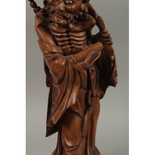 54 - A VERY FINE PAIR OF CHINESE CARVED HARDWOOD FIGURES, with inset bead eyes, 45cm high.