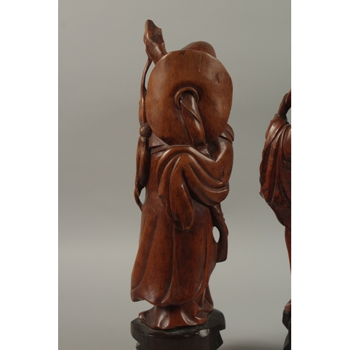 54 - A VERY FINE PAIR OF CHINESE CARVED HARDWOOD FIGURES, with inset bead eyes, 45cm high.