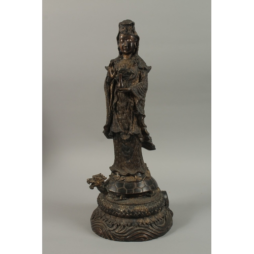 56 - A FINE AND LARGE CHINESE BRONZE FIGURE OF GUANYIN, stood upon a mythical turtle on a circular lotus ... 