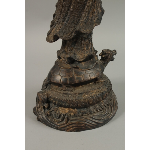 56 - A FINE AND LARGE CHINESE BRONZE FIGURE OF GUANYIN, stood upon a mythical turtle on a circular lotus ... 