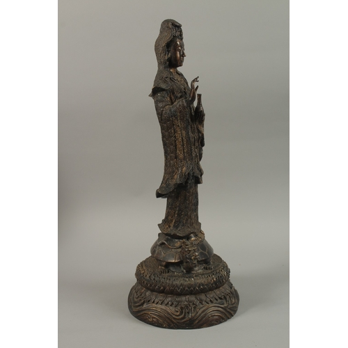 56 - A FINE AND LARGE CHINESE BRONZE FIGURE OF GUANYIN, stood upon a mythical turtle on a circular lotus ... 