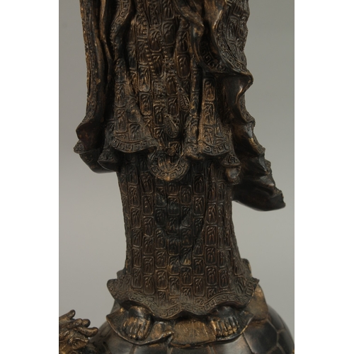 56 - A FINE AND LARGE CHINESE BRONZE FIGURE OF GUANYIN, stood upon a mythical turtle on a circular lotus ... 