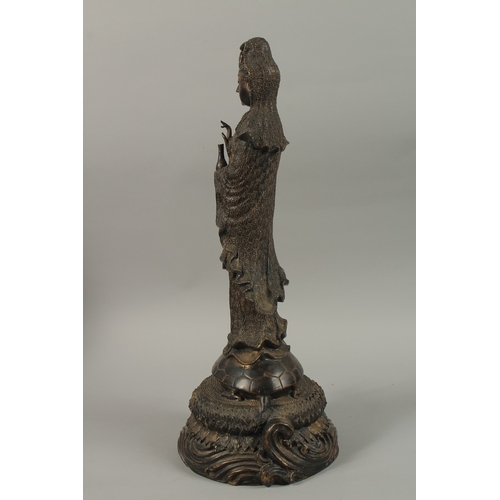 56 - A FINE AND LARGE CHINESE BRONZE FIGURE OF GUANYIN, stood upon a mythical turtle on a circular lotus ... 