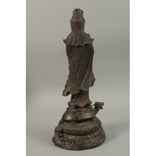 56 - A FINE AND LARGE CHINESE BRONZE FIGURE OF GUANYIN, stood upon a mythical turtle on a circular lotus ... 