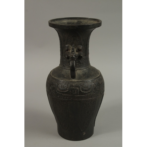 57 - A CHINESE BRONZE TWIN HANDLE VASE, with archaic designs and dragon head handles, character mark to b... 