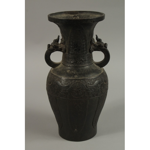 57 - A CHINESE BRONZE TWIN HANDLE VASE, with archaic designs and dragon head handles, character mark to b... 