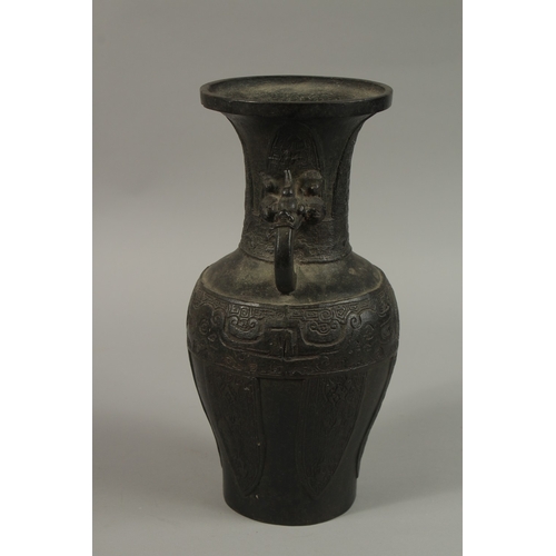 57 - A CHINESE BRONZE TWIN HANDLE VASE, with archaic designs and dragon head handles, character mark to b... 