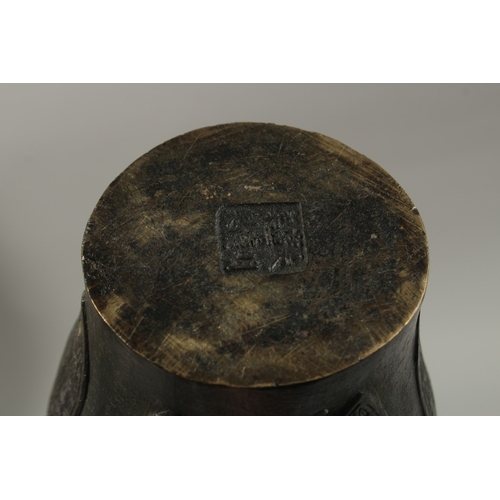 57 - A CHINESE BRONZE TWIN HANDLE VASE, with archaic designs and dragon head handles, character mark to b... 