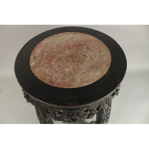 59 - A CHINESE RED MARBLE INSET HARDWOOD VASE STAND, of barrel form with carved and pierced frieze on fiv... 