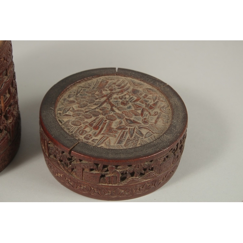 61 - A CHINESE FINELY CARVED BAMBOO LIDDED BRUSH POT, with a continuous village scene, 15cm high.