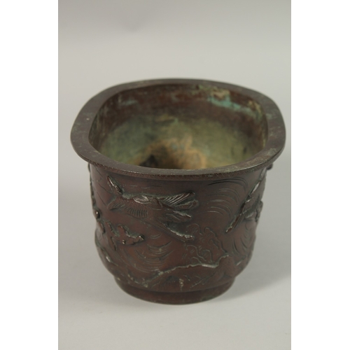 65 - A BRONZE OVAL FORM JARDINIERE, with relief decoration of cranes, the base with character mark, 22cm ... 