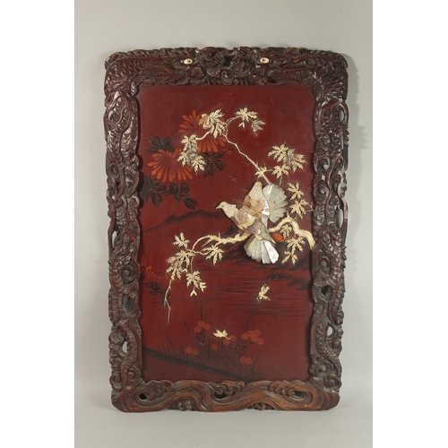 74 - A CHINESE BONE AND MOTHER OF PEARL INLAID LACQUERED HARDWOOD PANEL, depicting birds on a branch with... 