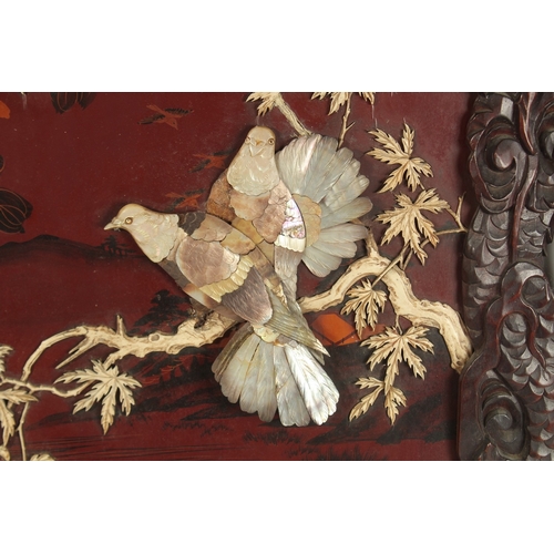 74 - A CHINESE BONE AND MOTHER OF PEARL INLAID LACQUERED HARDWOOD PANEL, depicting birds on a branch with... 