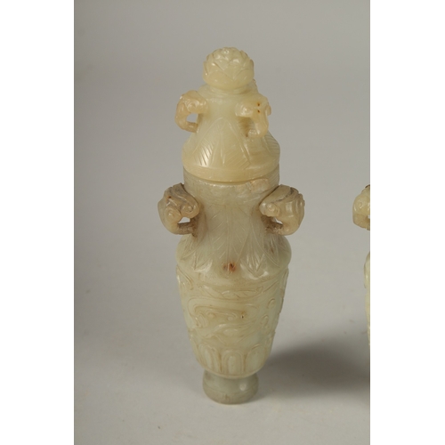 93 - A PAIR OF 18TH CENTURY CARVED JADE VASES AND COVERS, with ram mask handles and carved scrolls, 19cm ... 