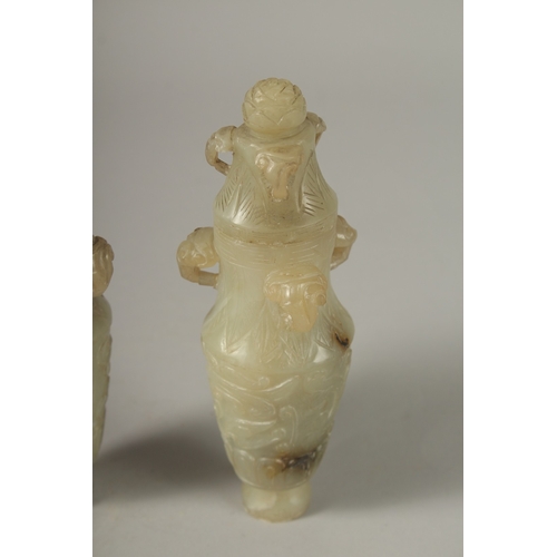 93 - A PAIR OF 18TH CENTURY CARVED JADE VASES AND COVERS, with ram mask handles and carved scrolls, 19cm ... 