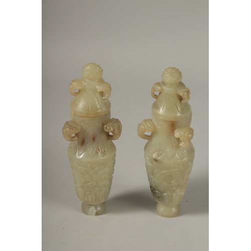 93 - A PAIR OF 18TH CENTURY CARVED JADE VASES AND COVERS, with ram mask handles and carved scrolls, 19cm ... 