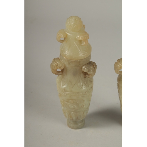 93 - A PAIR OF 18TH CENTURY CARVED JADE VASES AND COVERS, with ram mask handles and carved scrolls, 19cm ... 