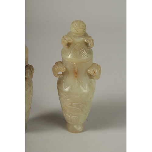 93 - A PAIR OF 18TH CENTURY CARVED JADE VASES AND COVERS, with ram mask handles and carved scrolls, 19cm ... 