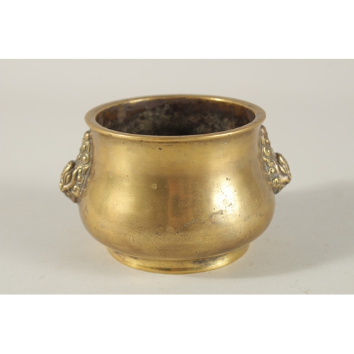 66 - A CHINESE BRONZE OR BRASS TWIN HANDLE CENSER, the base with six-character mark, 7.5cm high.