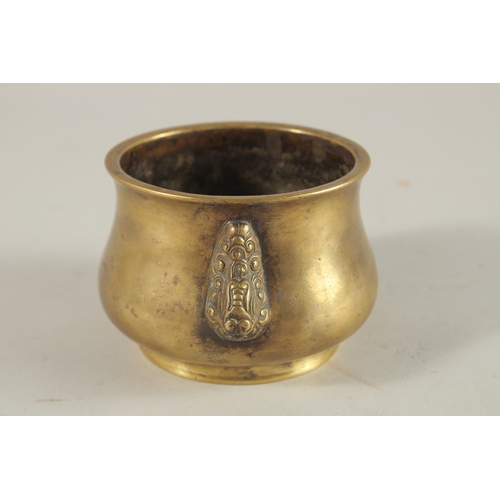 66 - A CHINESE BRONZE OR BRASS TWIN HANDLE CENSER, the base with six-character mark, 7.5cm high.