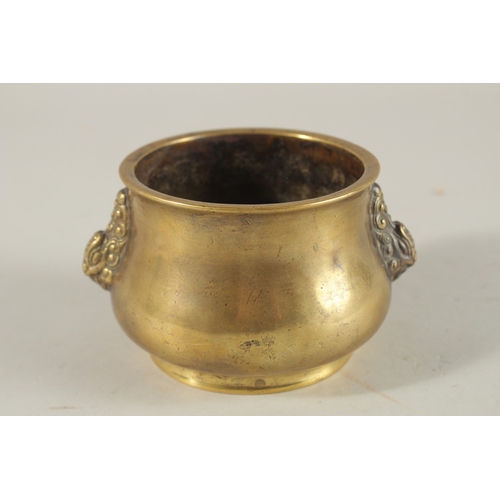 66 - A CHINESE BRONZE OR BRASS TWIN HANDLE CENSER, the base with six-character mark, 7.5cm high.