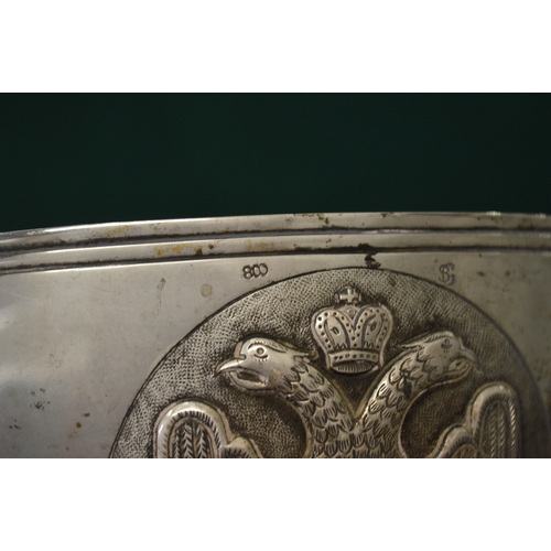 1046 - An unusual Continental silver circular bowl on four scroll feet, the body embossed with heraldic shi... 