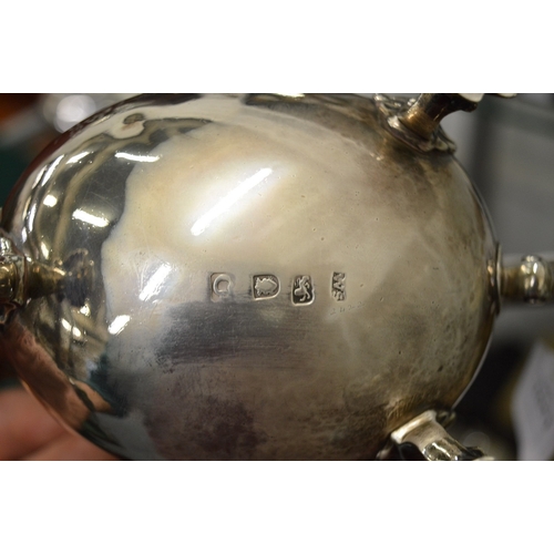 1051 - A good Georgian silver sauce boat with engraved armorial on three shell cast feet.