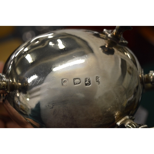 1051 - A good Georgian silver sauce boat with engraved armorial on three shell cast feet.