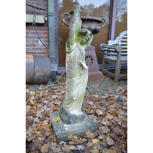 14 - A large reconstituted stone garden ornament modelled as a young lady carrying a pitcher.