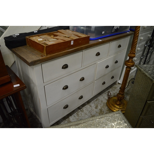 181 - A large painted and stained chest of drawers.