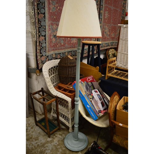 195 - A wire work rack, an oak stick stand and a painted standard lamp.