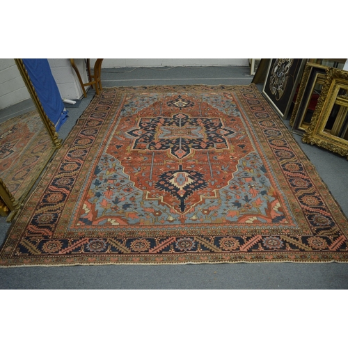 326 - A good Persian carpet, early 20th century, red and blue ground with stylised decoration, 336cm x 253... 