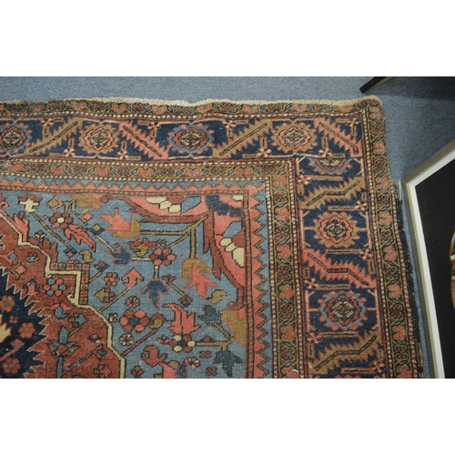 326 - A good Persian carpet, early 20th century, red and blue ground with stylised decoration, 336cm x 253... 