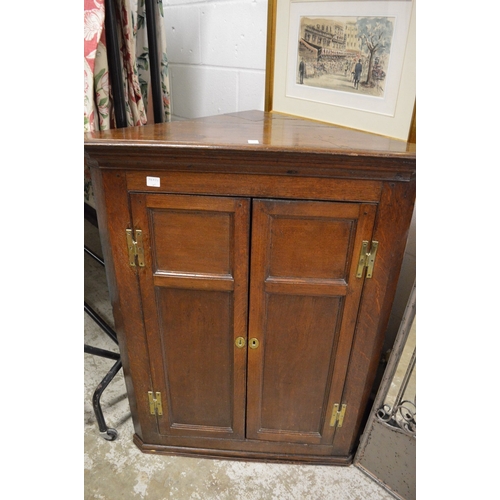 338 - A 19th century oak hanging two door corner cupboard.