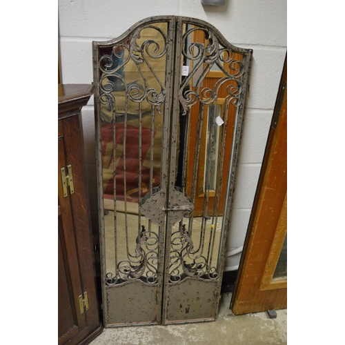 339 - Decorative wrought iron mirror with hinged panels.