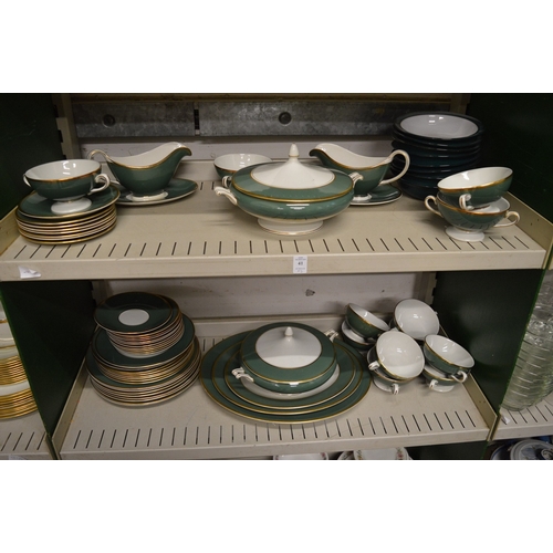 41 - A dinner service decorated with green and gilt bands.