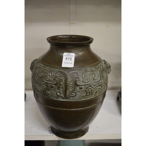 572 - A Chinese bronze twin handled vase with a band of decoration.