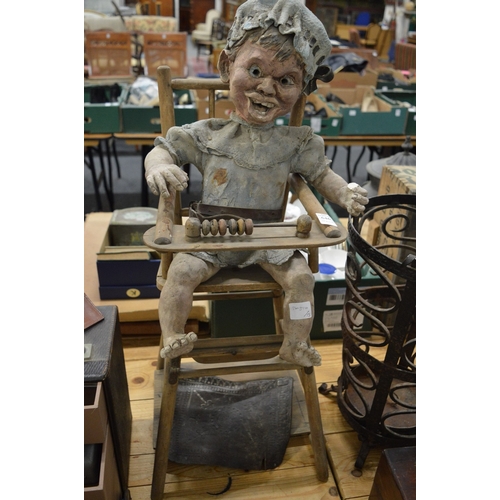 646 - Model of a child in a high chair.