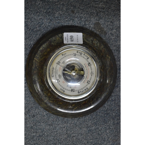 650 - A serpentine barometer.