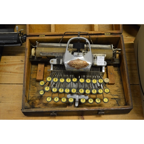 722 - A Blickensderfer Featherweight aluminium typewriter and two other typewriters.