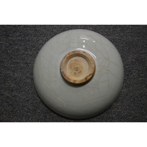 760 - A Chinese celadon glazed circular dish with incised decoration.