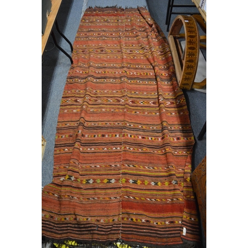 779 - A Kilim style rug, 300cm x 120cm.