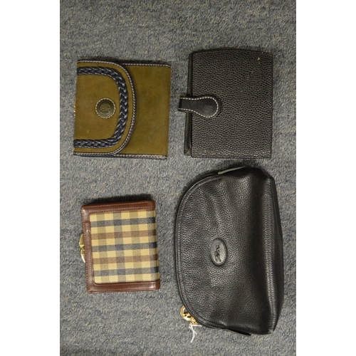 808 - A ladies Longchamp black leather purse and three other purses.