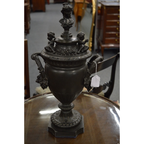 823 - A good pair of classical design bronze twin handled urns and covers.