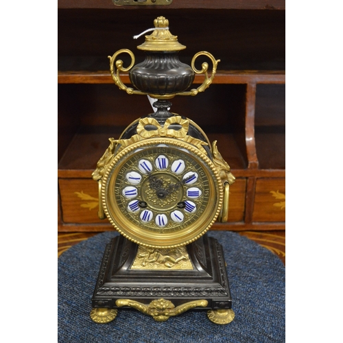 826 - A good French bronze and gilt bronze mantel clock with urn shape finial and enamel numerals.