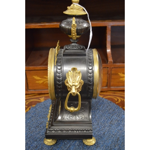 826 - A good French bronze and gilt bronze mantel clock with urn shape finial and enamel numerals.