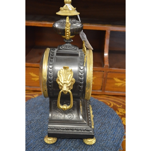 826 - A good French bronze and gilt bronze mantel clock with urn shape finial and enamel numerals.