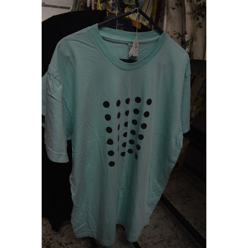 829 - Two Damien Hirst pale green T shirts.