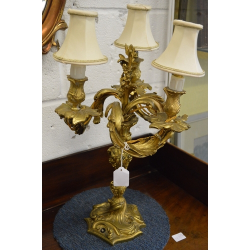 852 - A good pair of Louis XVI style ormolu three branch candelabra.