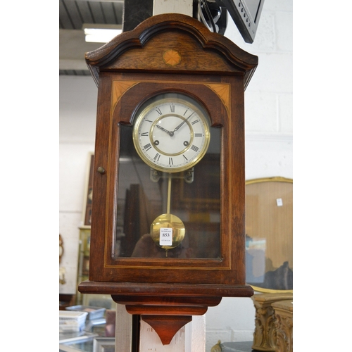 853 - A mahogany cased wall clock.